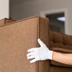 Man Holding a White Glove Sofa Delivery